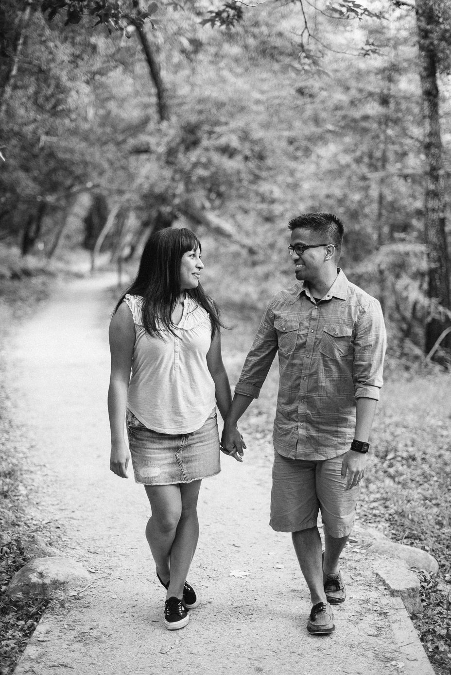 black and white engagement photo walking in Pfeiffer state park