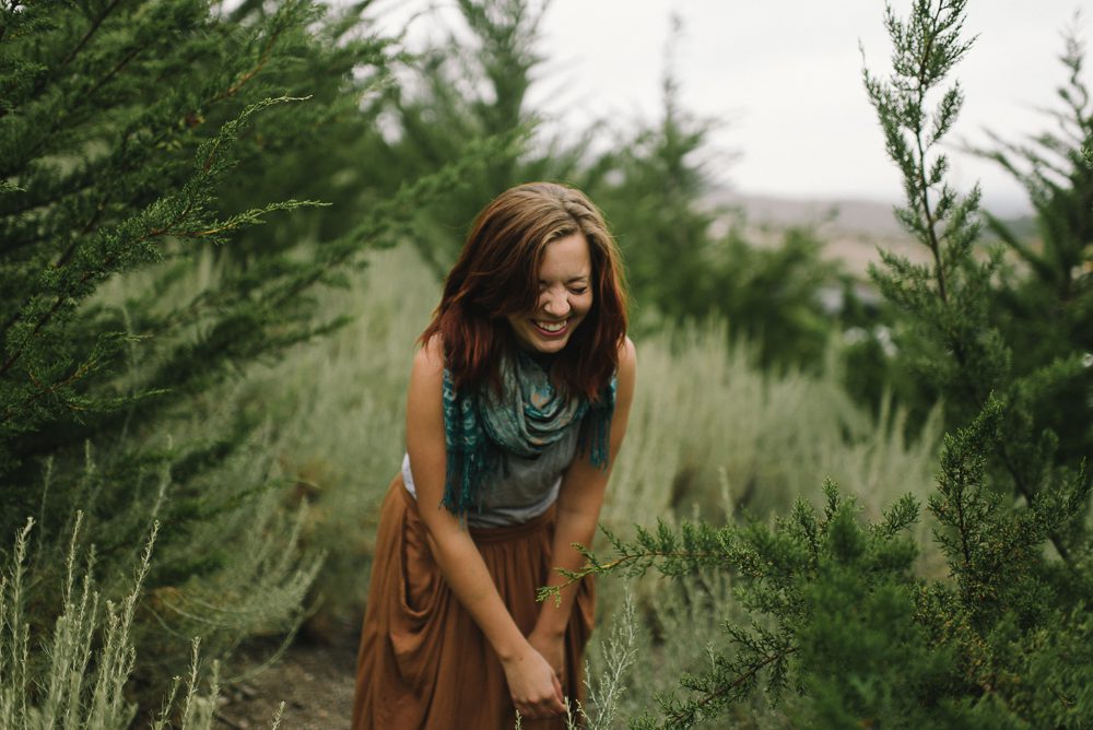 woman walking at irish hills in san luis obispo, laughing in trees