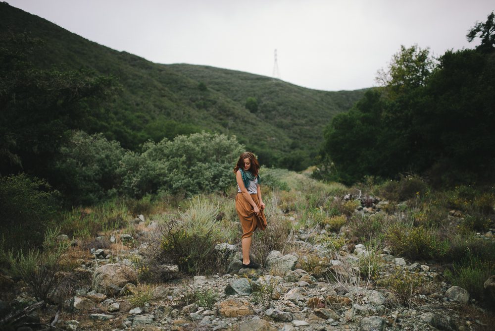 woman walking at irish hills in san luis obispo, standing on rocks