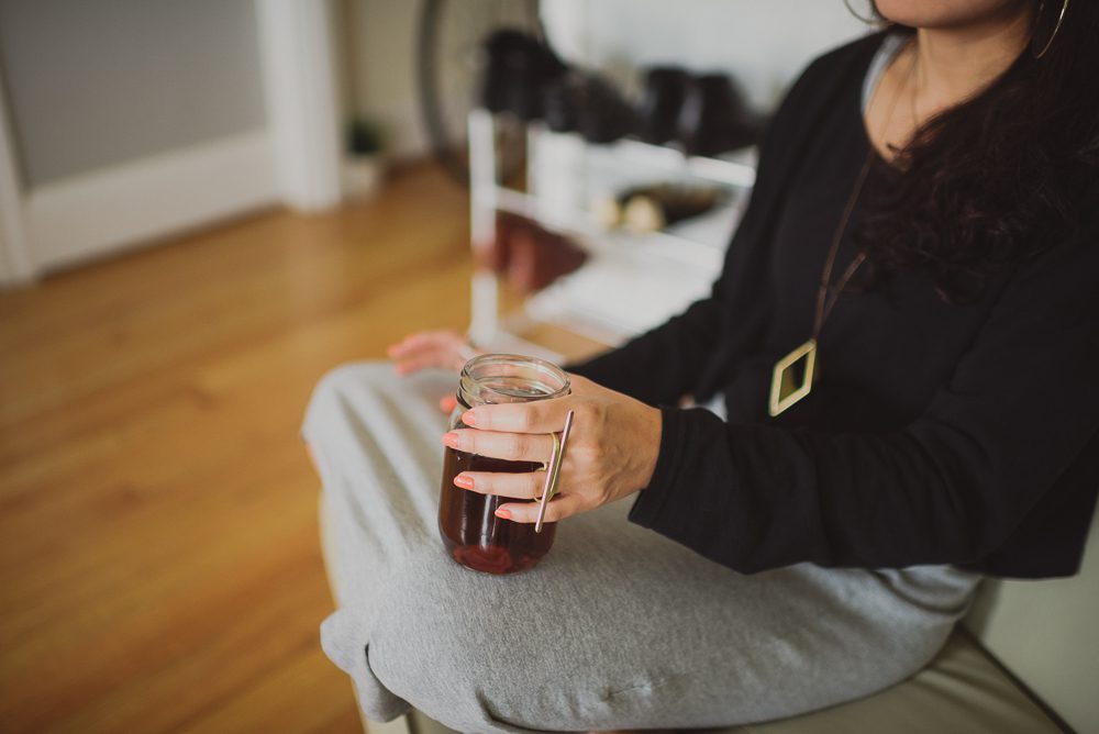 woman drinking tea on her couch