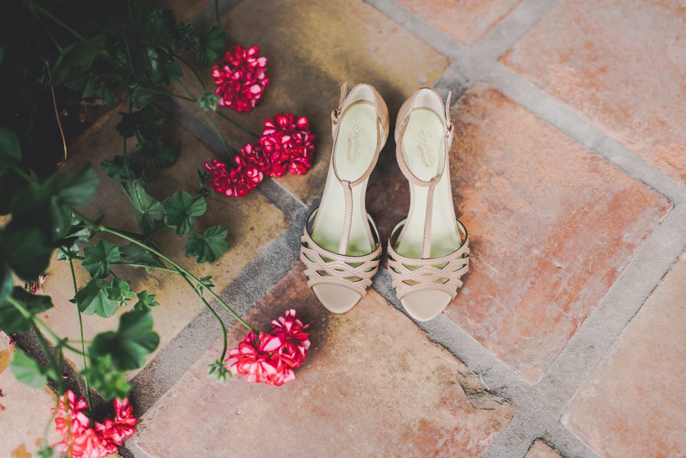pink brides shoes near geranium plant