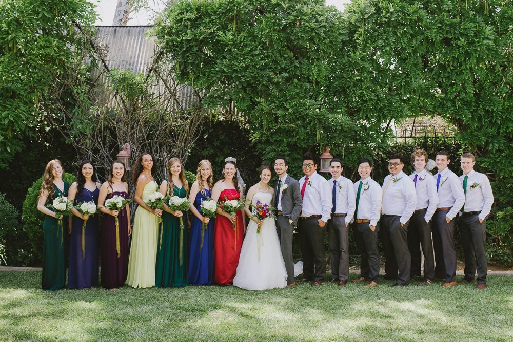 whole wedding party with multicolor dresses and ties