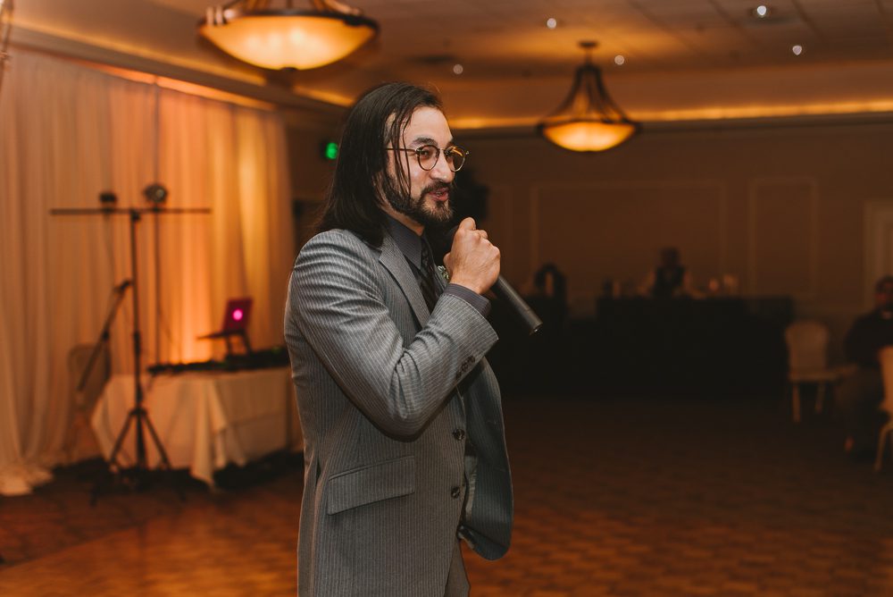 brother giving speech during wedding reception