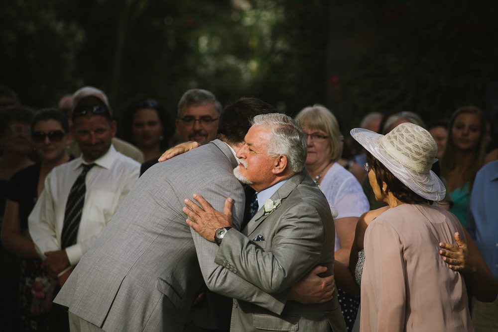 groom hugging father of the bride at Wedding Party at San Joaquin River Parkway Wedding