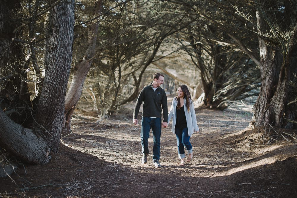 Couple walking through tunnel of trees