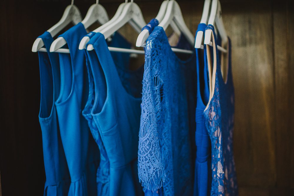 blue bridesmaid dresses hanging in closet