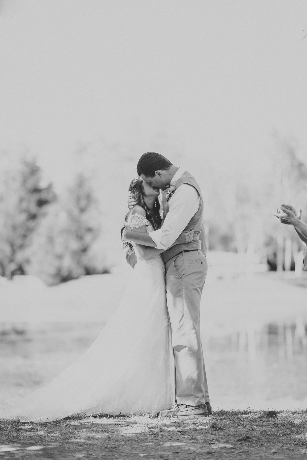 black and white of bride and grooms first kiss
