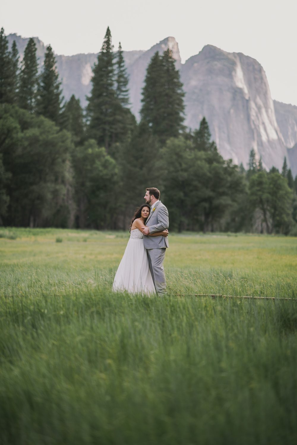 Bride and groom standing in yosemite valley