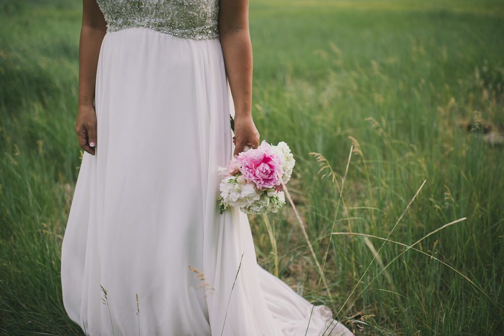 Bride holding bouquet at side