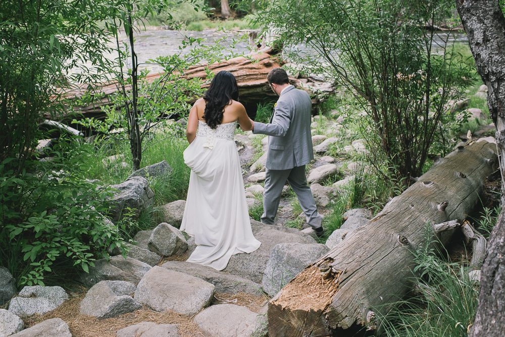 Bride and Groom walking down to creek
