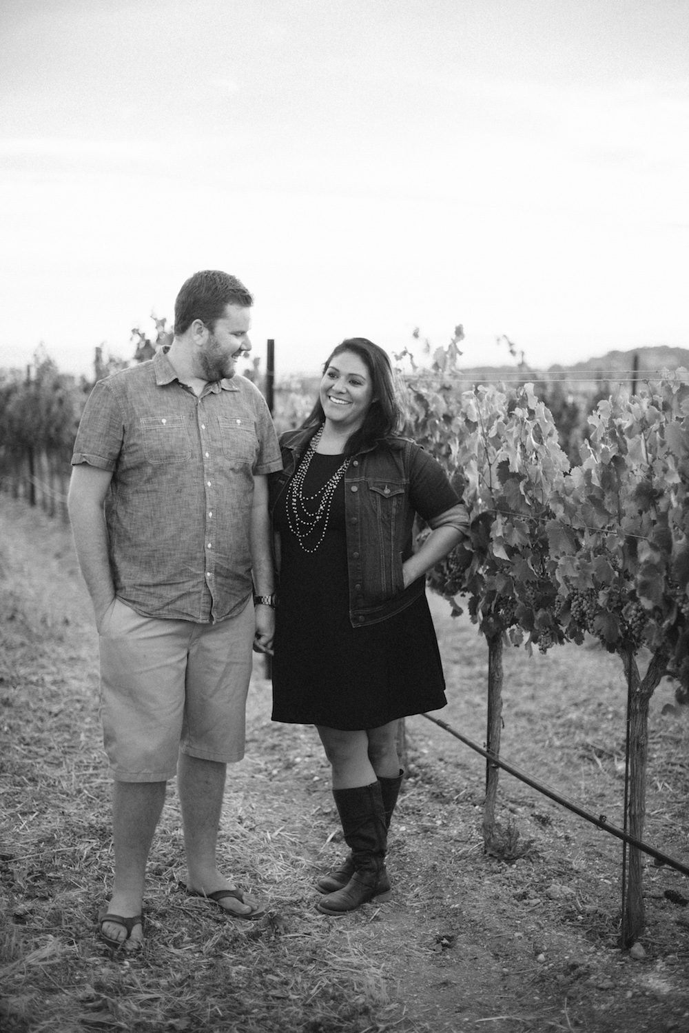 couple posing in a vineyard in templeton