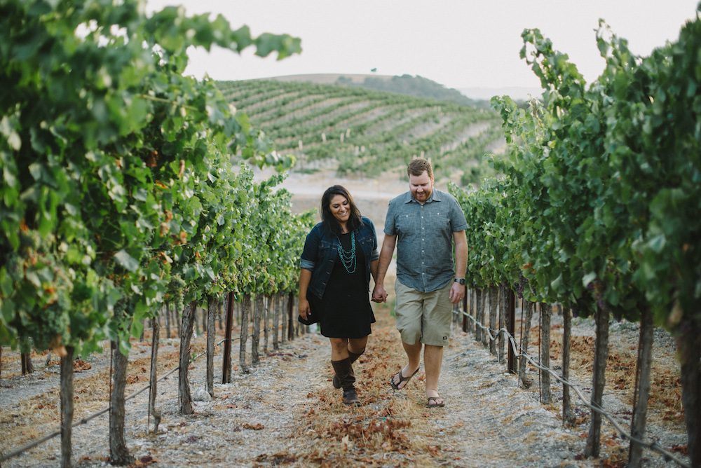 Couple walking up a vineyard