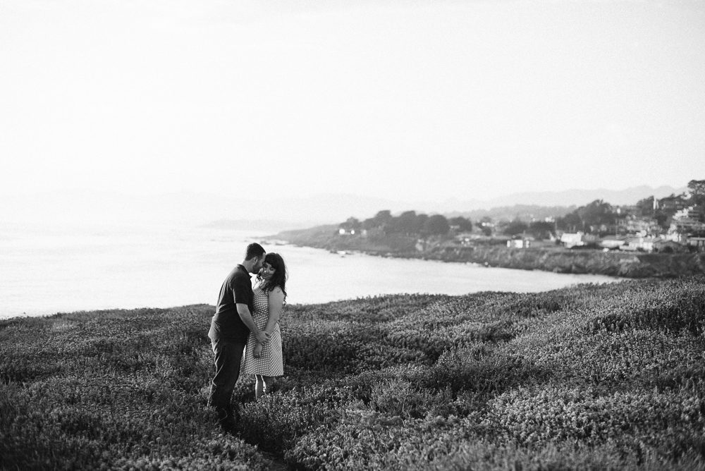 Couple standing on coast in cambria california for engagement photos