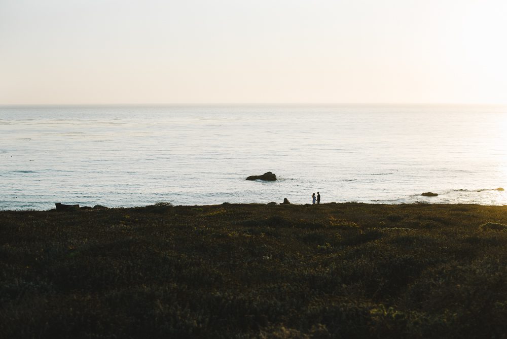 Couple standing on coast in cambria california for engagement photos