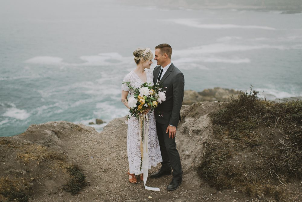 couple standing on cliff at montana de oro