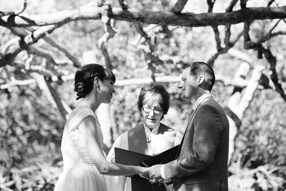 black and white of bride and groom saying their vows