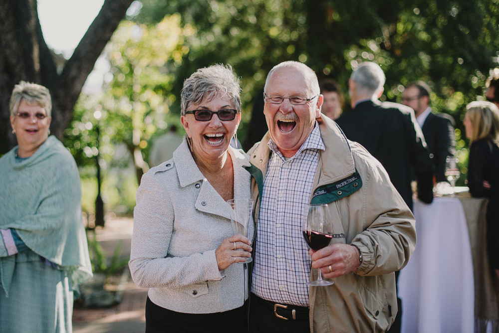 two people laughing at a wedding reception