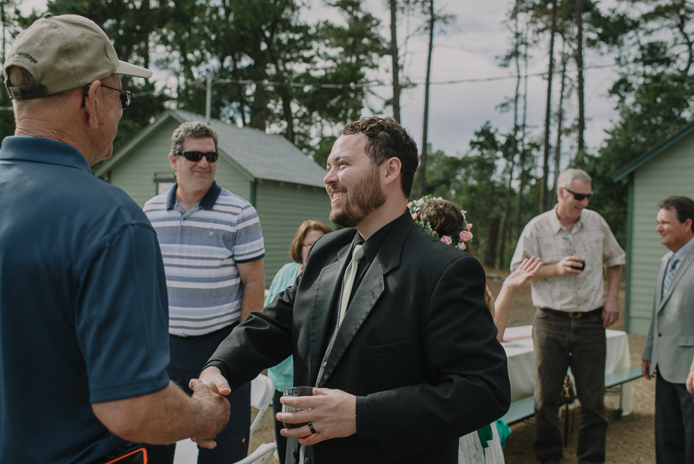 groom shaking guests hand