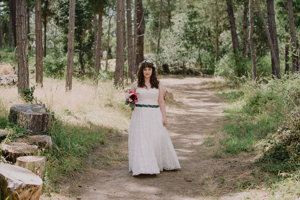 bride walking through forest 
