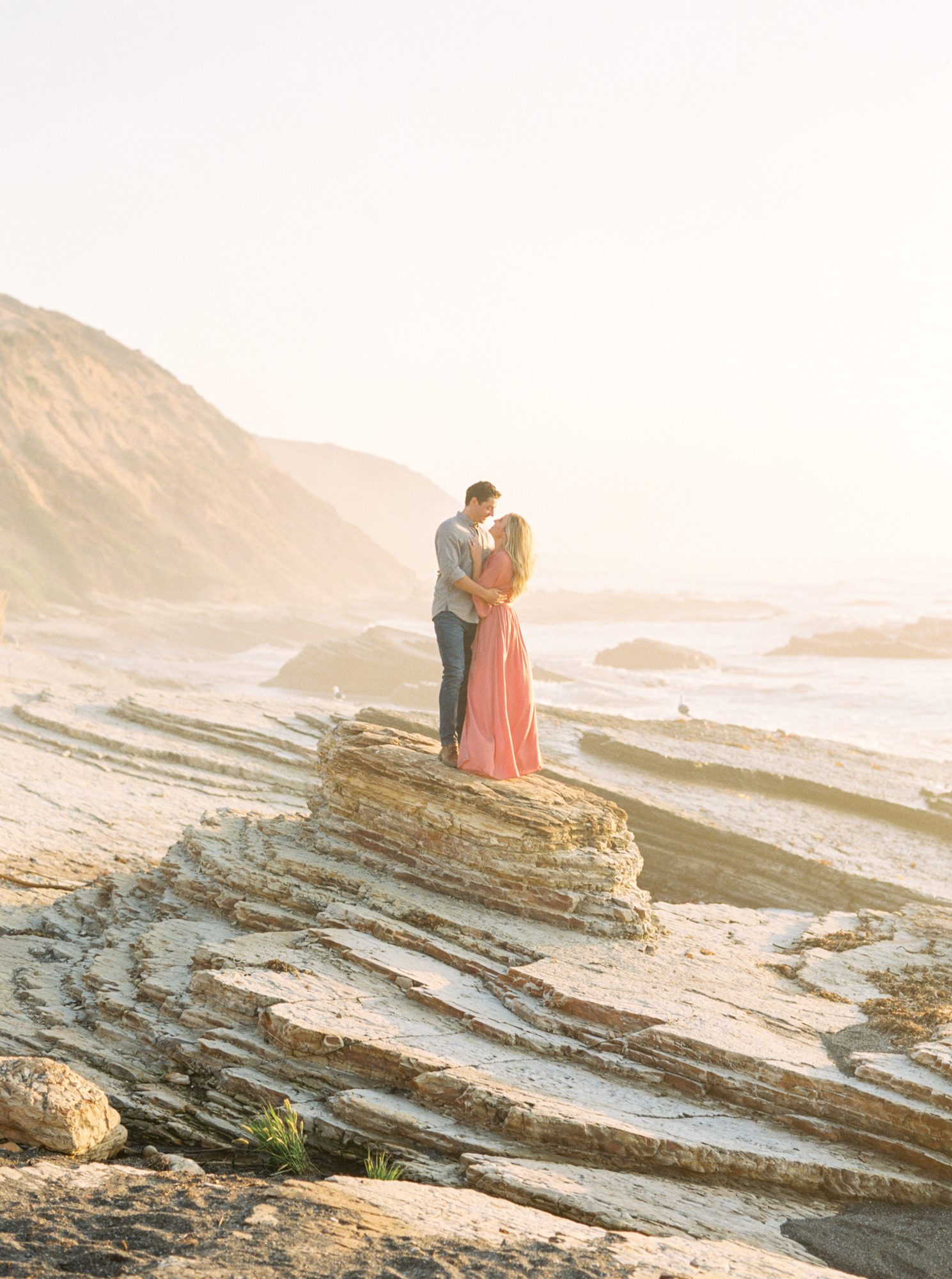 Couple pose on a rocky beach for Tina Loveridge, a Santa Barbara Wedding photographer